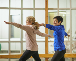 Two women exercise together.